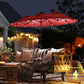 Wine red outdoor patio umbrella open at dusk with visible LED lights under canopy