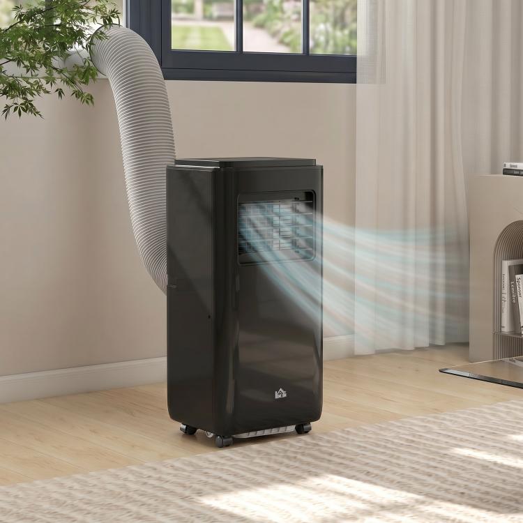 Black portable air conditioner standing indoors with attached exhaust hose