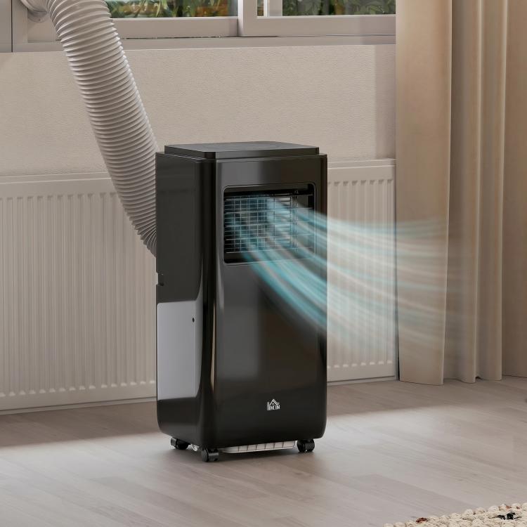 Black portable air conditioner near radiator with exhaust hose extended
