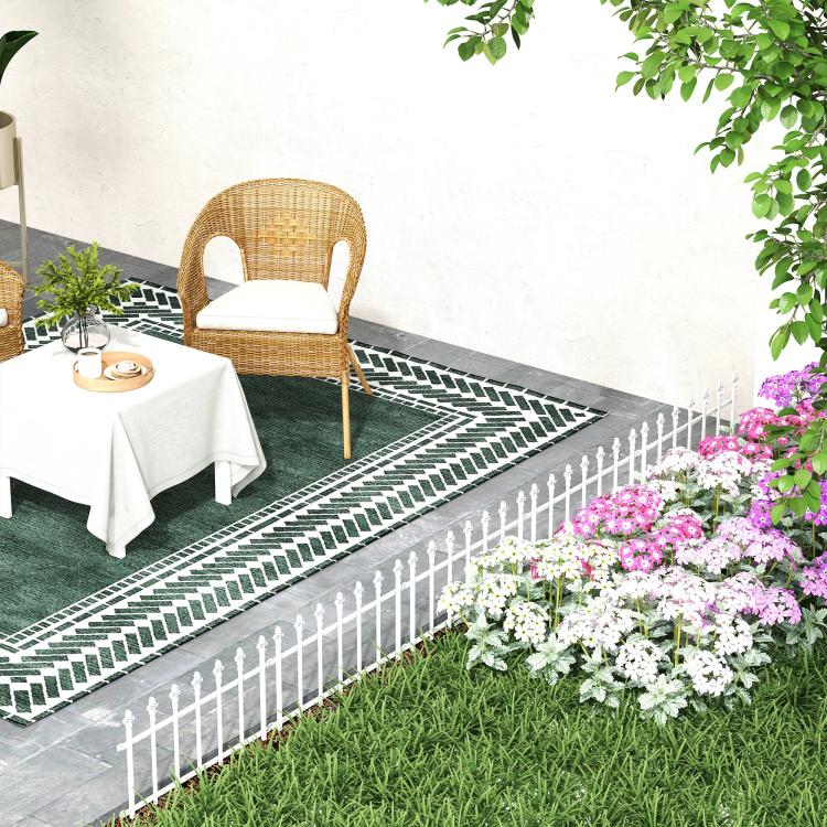 White metal landscape border fence along patio edging with flowers