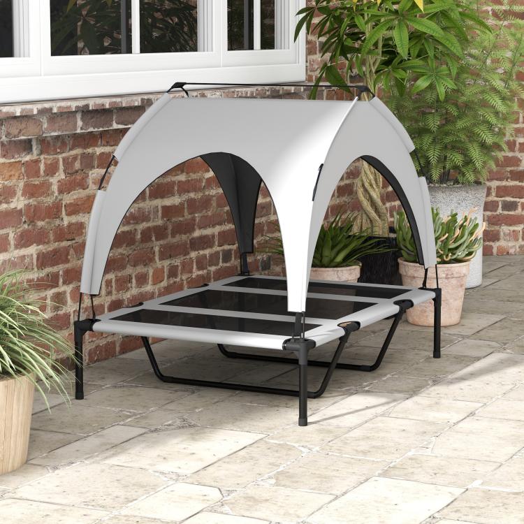 Raised outdoor dog bed with gray canopy, breathable mesh windows, black frame, legs