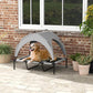 Elevated canopy dog bed with gray cover and black mesh, dog resting on cot surface
