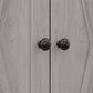 Light gray cabinet door with two round bronze knobs