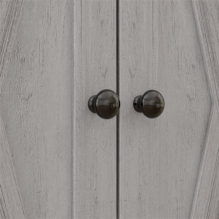 Light gray cabinet door with two round bronze knobs