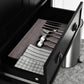 Black cabinet drawer interior with utensil dividers and folded linens