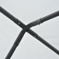 Black metal tunnel greenhouse frame corner joint with mesh fabric.