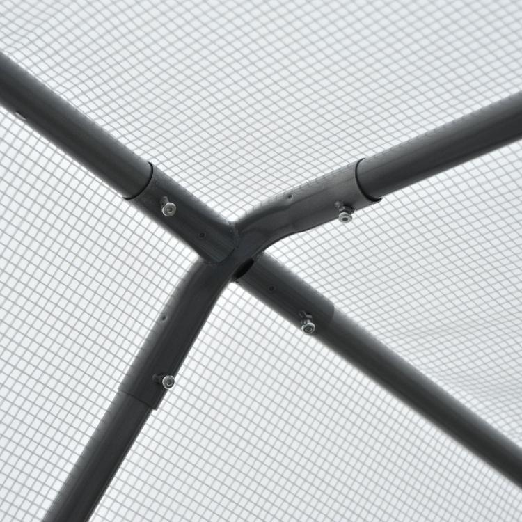 Black metal tunnel greenhouse frame corner joint with mesh fabric.