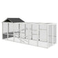 Gray wooden chicken coop run with gable roof, wire mesh sides, and ramp