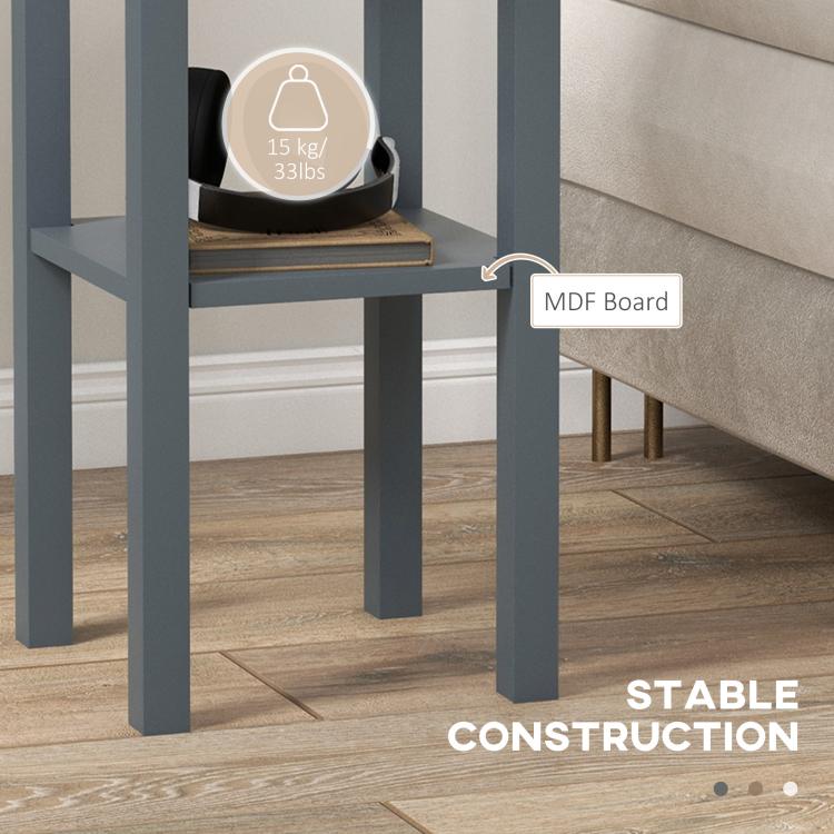 Gray lower shelf area of the side table, holding a storage bin under the drawer.