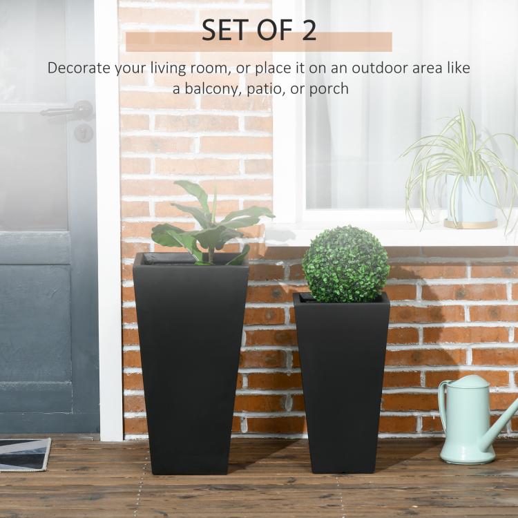 Two black tall square planters with potted greenery