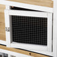 Close-up of rabbit hutch door with white frame, wire mesh panel, and metal latch