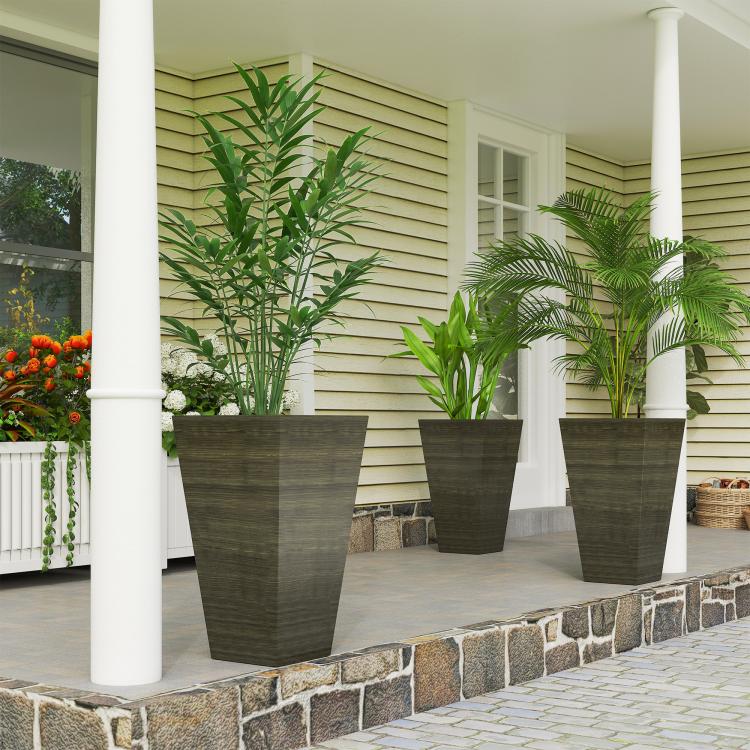 Set of 3 tall dark brown wood-look plastic outdoor planters with leafy plants