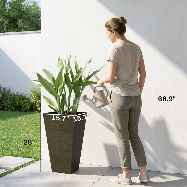 Tall dark brown wood-look plastic planter being moved by a person outdoors