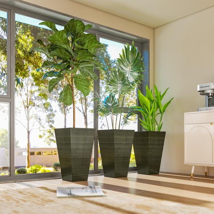 Set of 3 tall dark brown wood-look plastic planters indoors with tropical plants
