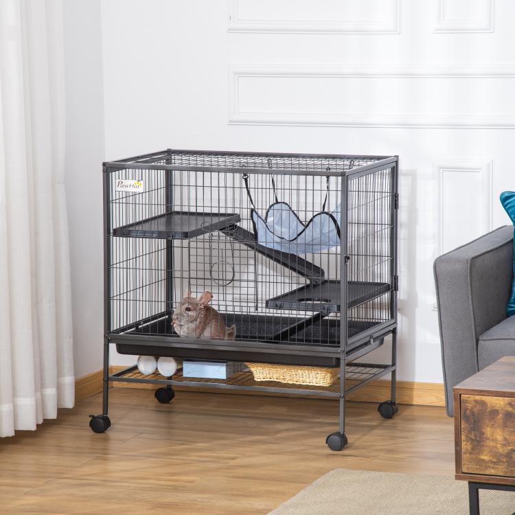 Multi-level black wire pet cage with ramp, blue hammock, and removable tray