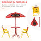 Folding kids table and two yellow folding chairs with red ladybug umbrella canopy