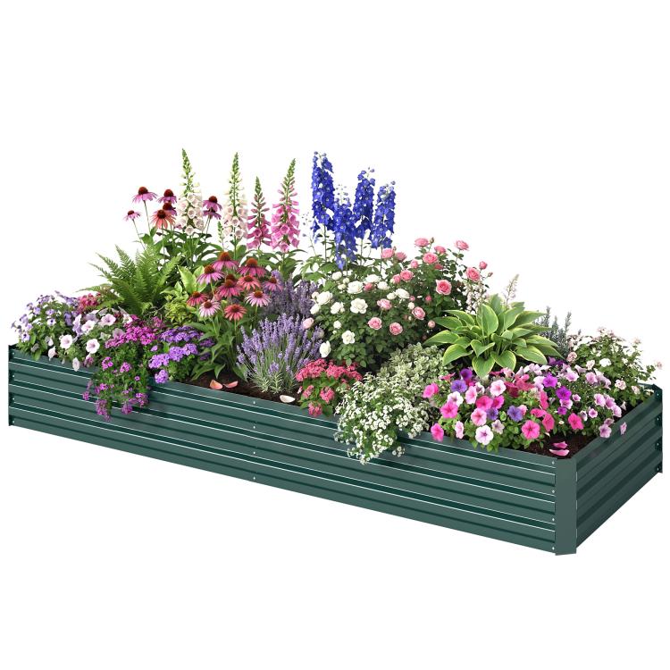 Green raised garden bed planted with mixed colorful flowers and blooming plants