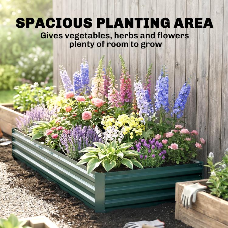 Green raised garden bed packed with colorful flowers in a neat row