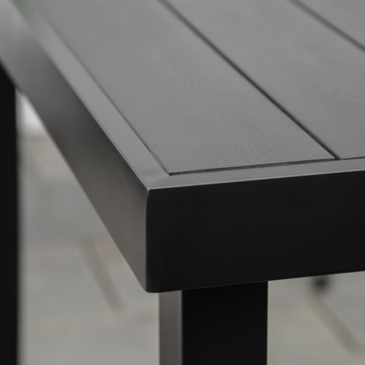 Close-up of black tabletop edge and corner leg for outdoor dining table