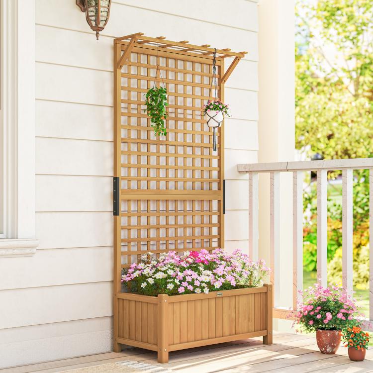 Wood trellis planter with raised bed and flower plants, light wood frame in patio
