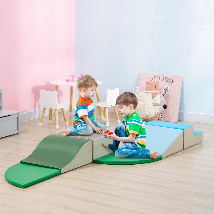 Kids playing on foam climbing blocks with blue and green platforms