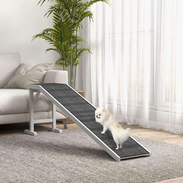 Foldable dog ramp with dark non-slip carpet tread and white side supports in living room