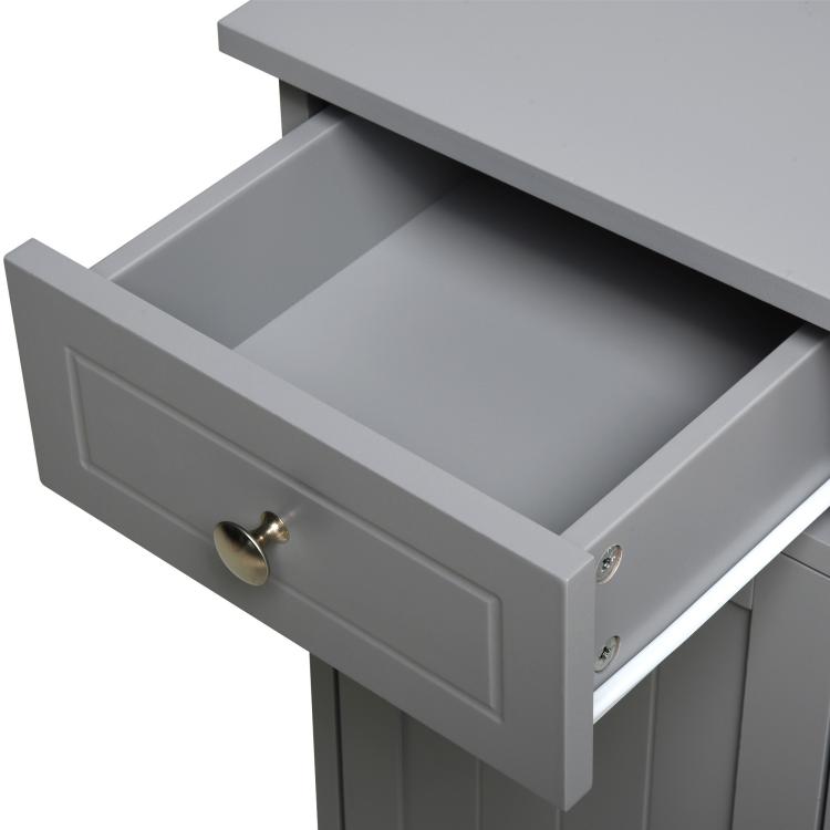 Gray freestanding bathroom floor cabinet with open drawer and brass pull hardware