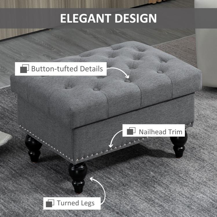 Gray button-tufted ottoman with nailhead trim and turned legs