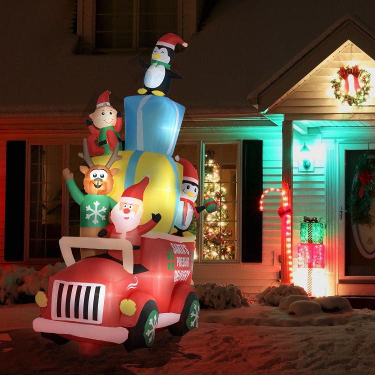 Illuminated inflatable Santa gift car with penguin top figure and festive characters