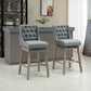Set of 2 gray button-tufted bar stools with padded seats and wood legs