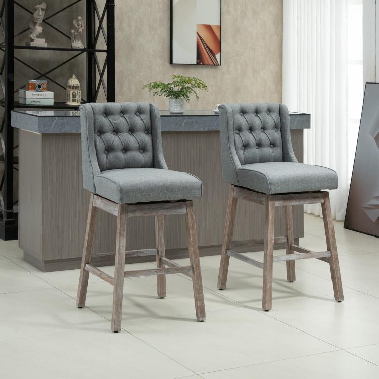 Set of 2 gray button-tufted bar stools with padded seats and wood legs