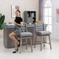 Gray upholstered bar stools with button-tufted backs and padded seats in a home setting