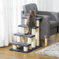 Cat climbing tower with four dark steps and cream sisal posts, cat perched on top
