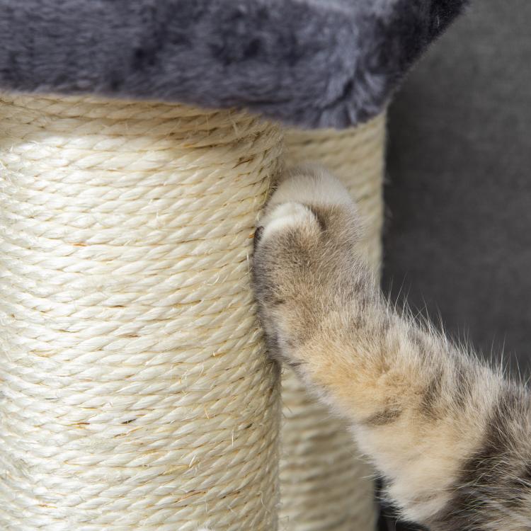 Cat paw scratching cream sisal rope on a wrapped cat-tower post