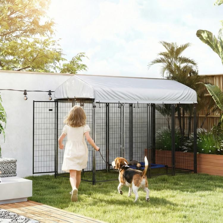 Outdoor dog kennel with roof, black wire enclosure with dog in grassy yard