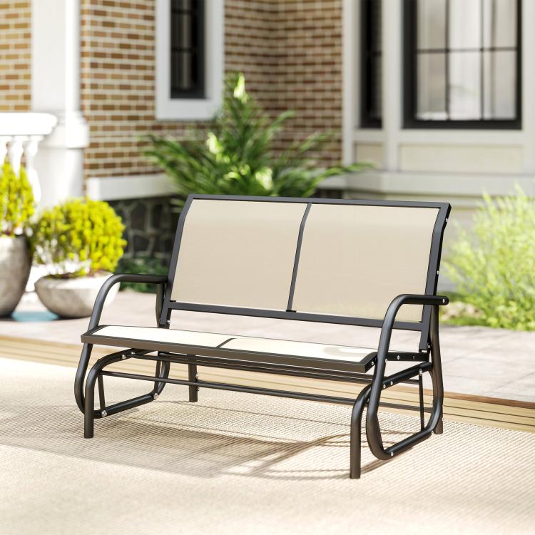 Outdoor glider bench with beige seat cushions and black metal rocking frame