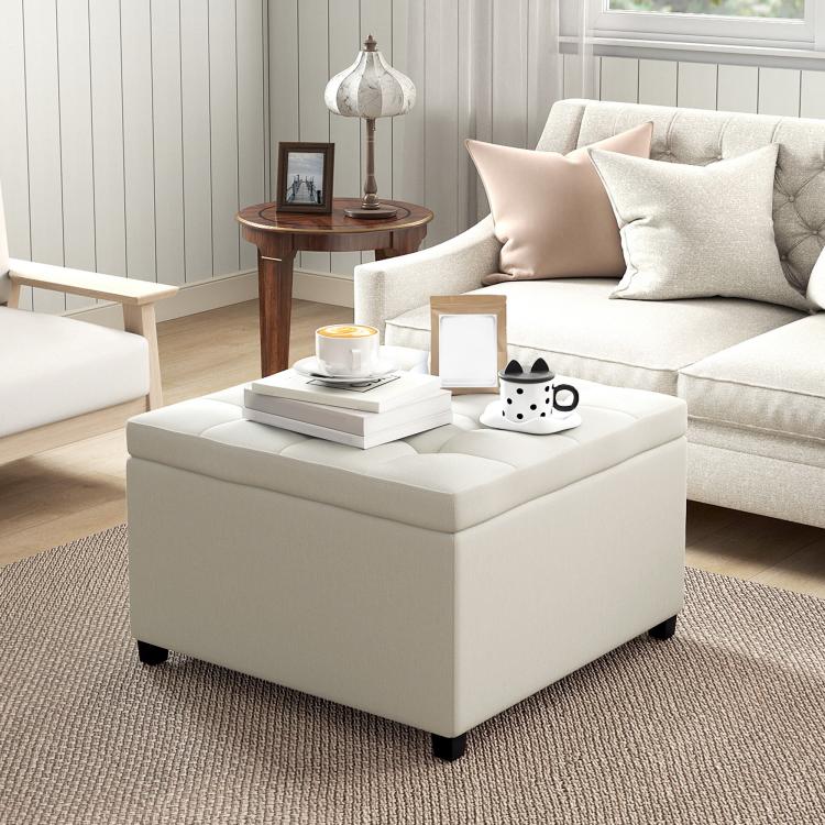 Beige square ottoman bench with button-tufted seat and padded sides, dark feet