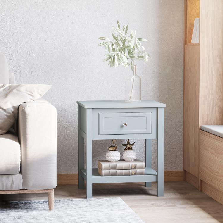 Light gray end table with drawer and open lower shelf, styled with decor
