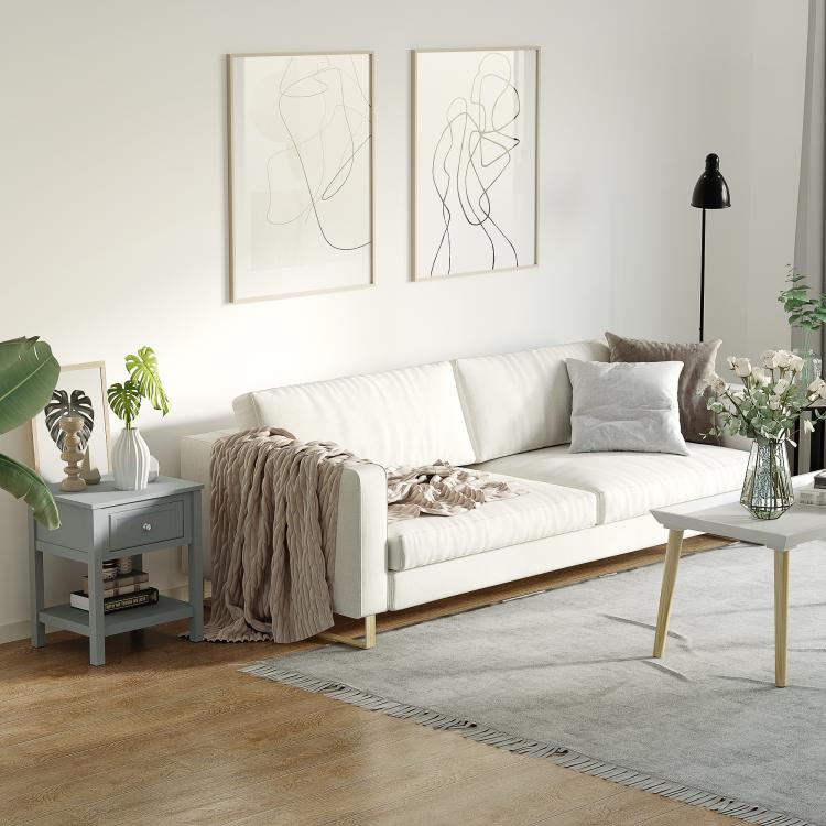Light gray end table with storage drawer and bottom shelf next to sofa