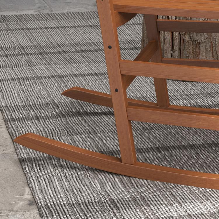 Close-up of brown rocking chair base with curved rockers and support frame