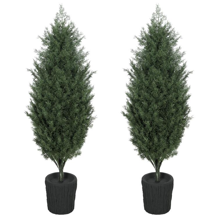 Two faux cedar mini trees with dense green foliage in black textured planters