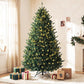Prelit Colorado blue spruce Christmas tree with warm white lights and wrapped gifts at base
