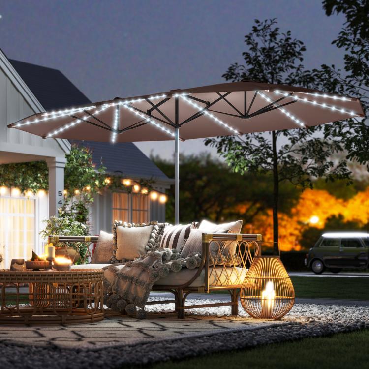 Tan patio umbrella with glowing white LED lights on the canopy frame