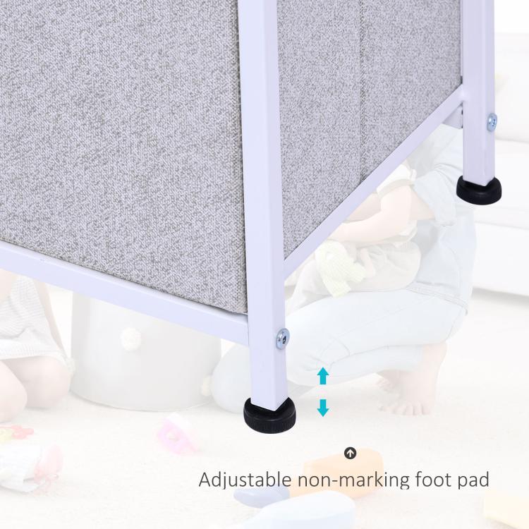 Adjustable non-marking foot pads on white frame of light gray fabric drawer dresser.