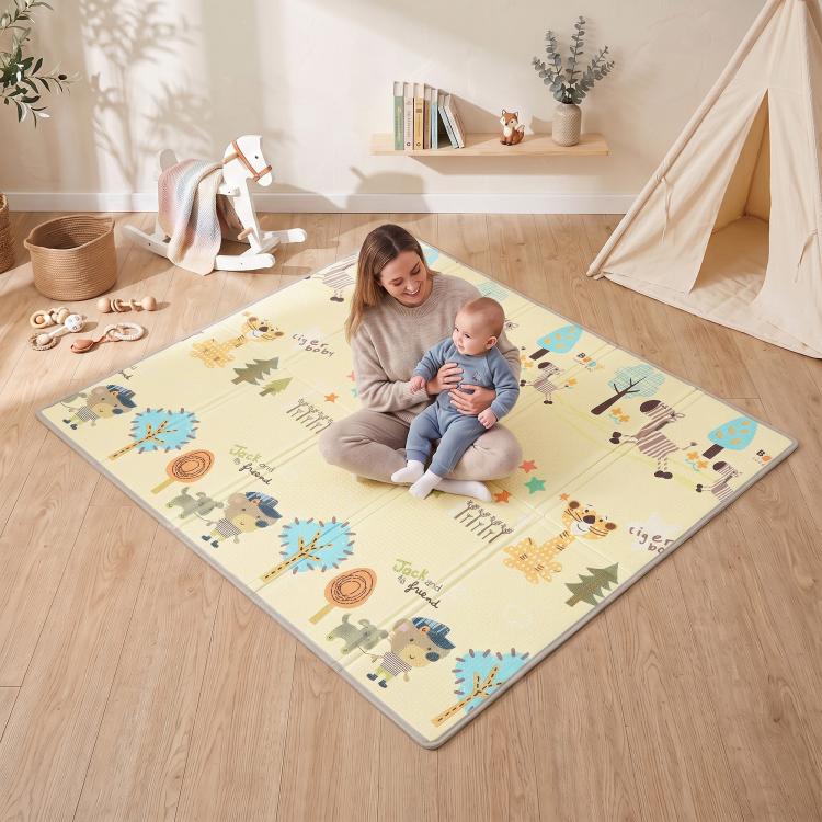 Forest animal reversible play mat with padded edges, beige and blue, child playing