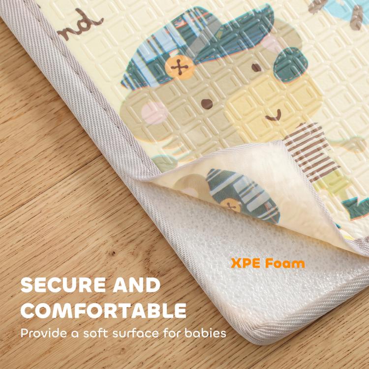 Reversible play mat close-up with stitched edge and soft foam layer, forest animals print