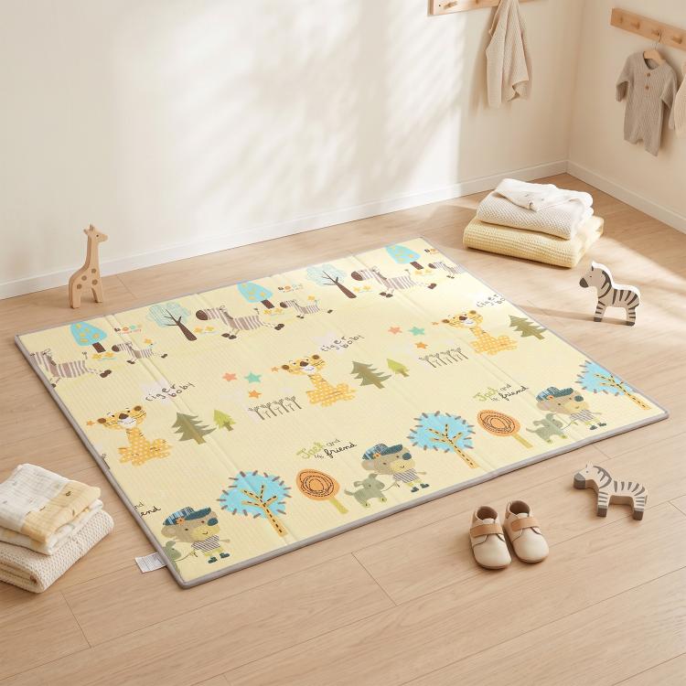 Reversible forest animal baby play mat on floor, beige with colorful wildlife illustrations