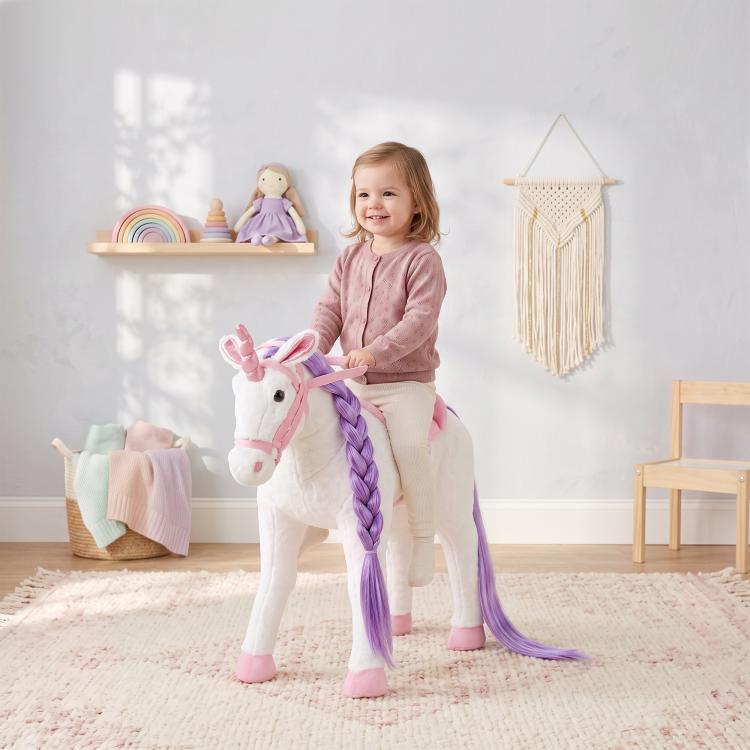 White plush ride-on horse toy with purple braided mane and pink accents