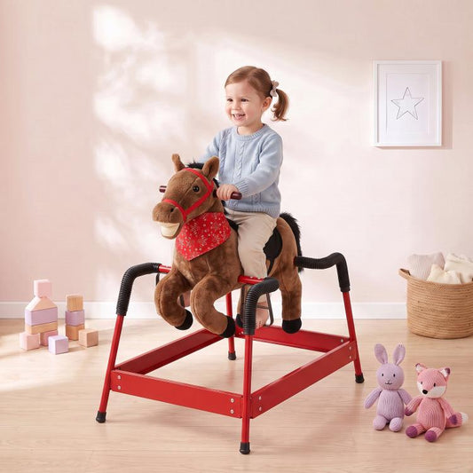 Brown plush rocking horse ride-on with red saddle, child seated, black handrails