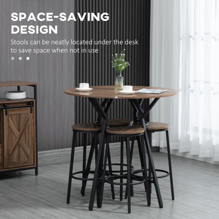 Round bar table with four stools, black metal frames with wood-look seats.